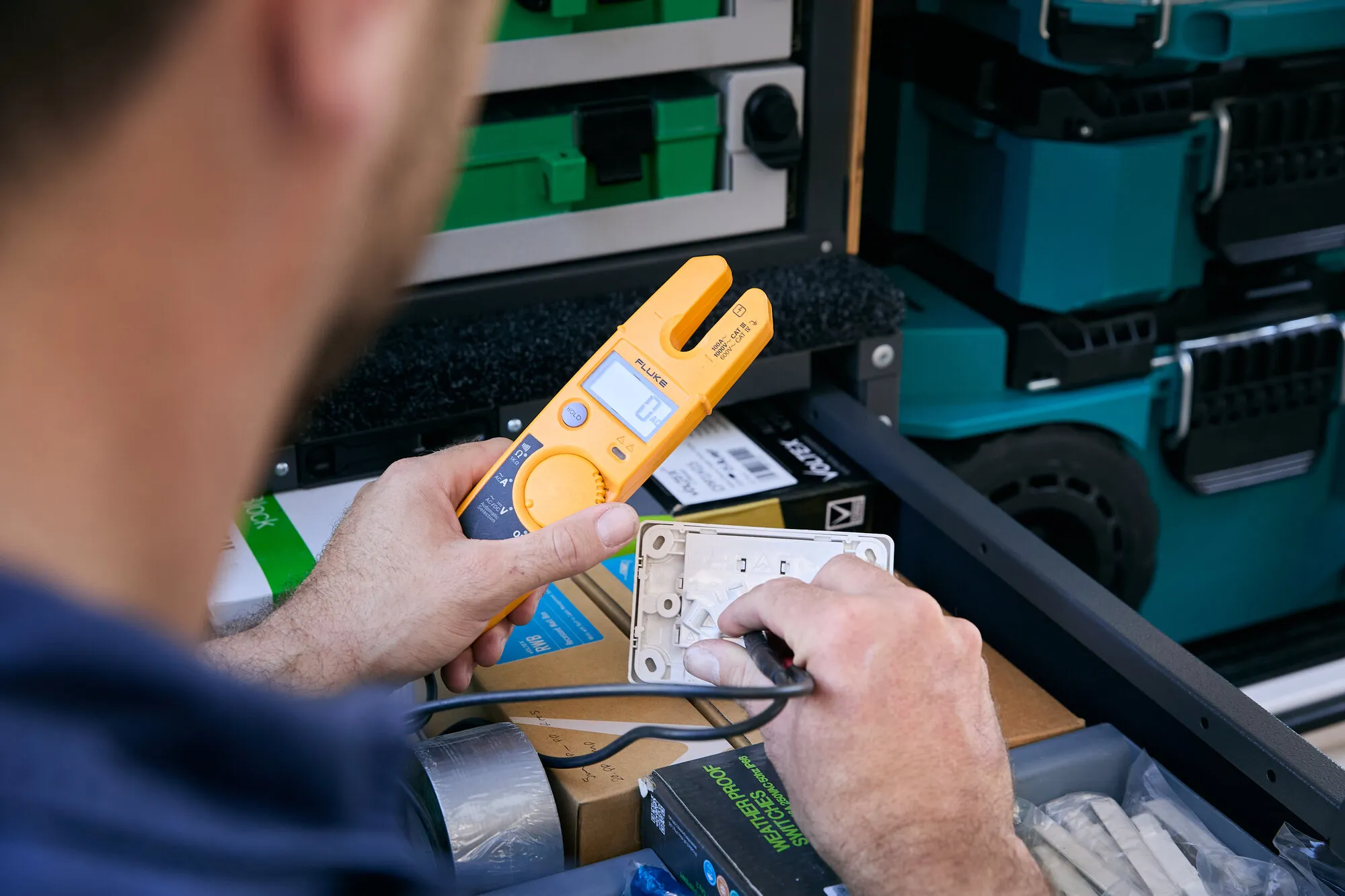 Kitson electrician fault-finding a power point with a multimeter